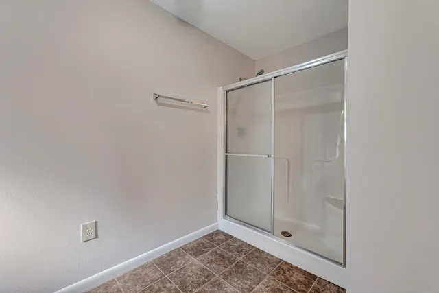 a bathroom with a glass shower door