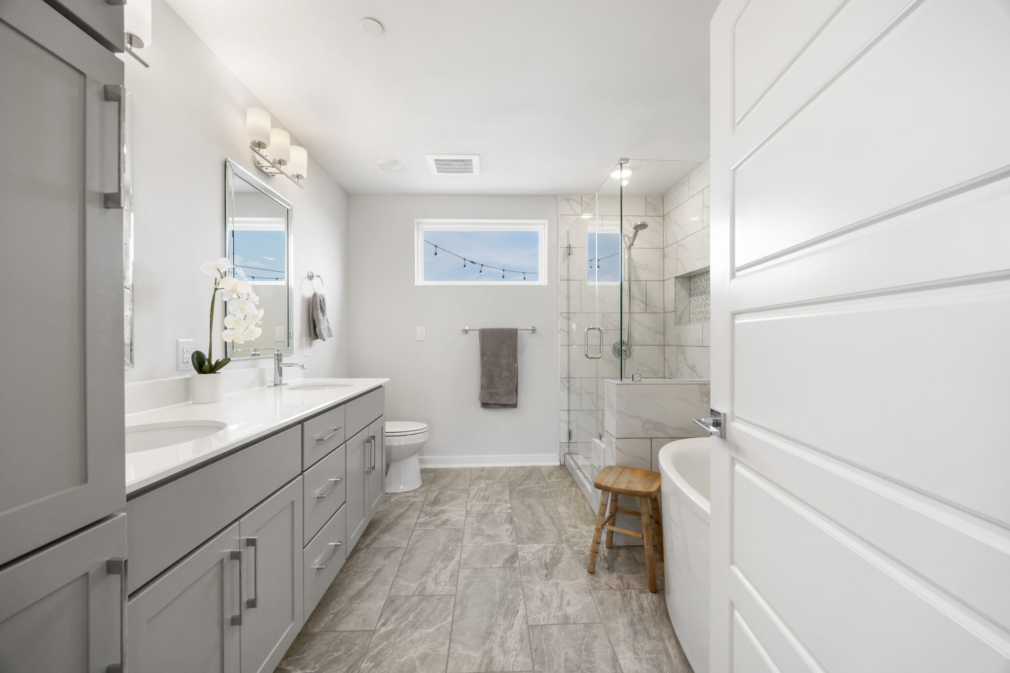 1417 Kramer Lane, Unit 14 Austin, TX 78758 - Photo 20 of 33 Bathroom with a stall shower, double vanity, and a freestanding tub
