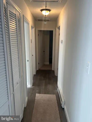 a view of hallway with wooden floor