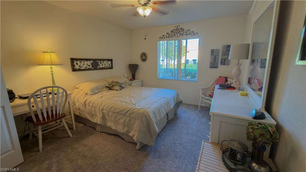 8298 Key Royal Lane, Unit 413 Naples, FL 34119 - Photo 16 of 18 Carpeted bedroom featuring ceiling fan and an office area