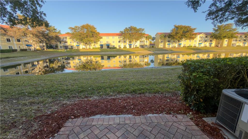 8298 Key Royal Lane, Unit 413 Naples, FL 34119 - Photo 6 of 18 View of green lawn with a water view