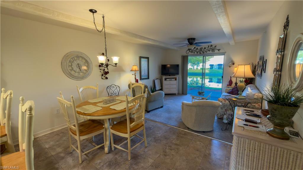 8298 Key Royal Lane, Unit 413 Naples, FL 34119 - Photo 10 of 18 Dining area with hanging lights, beamed ceiling, and ceiling fan