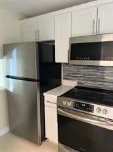 a stove top oven sitting inside of a kitchen