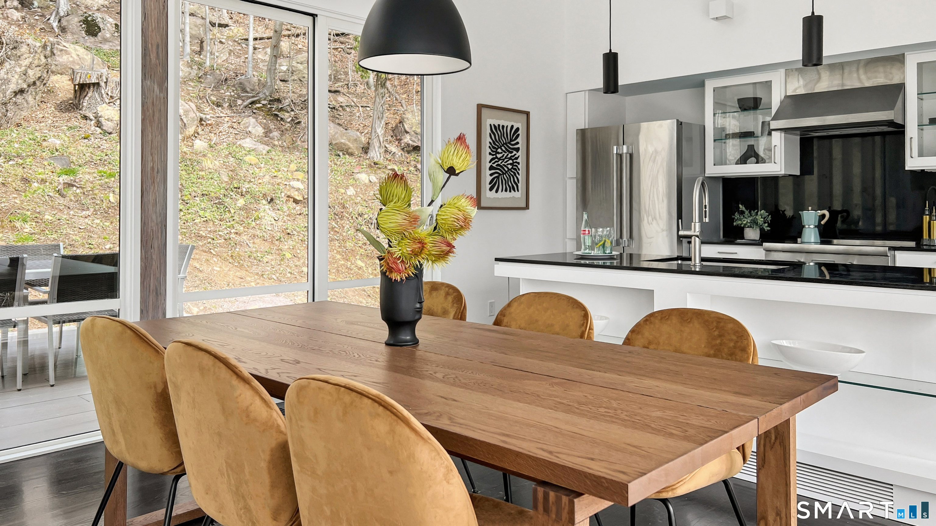169 Mill Rock Road Hamden, CT 06517 - Photo 14 of 40 a dining table with chairs and chandelier