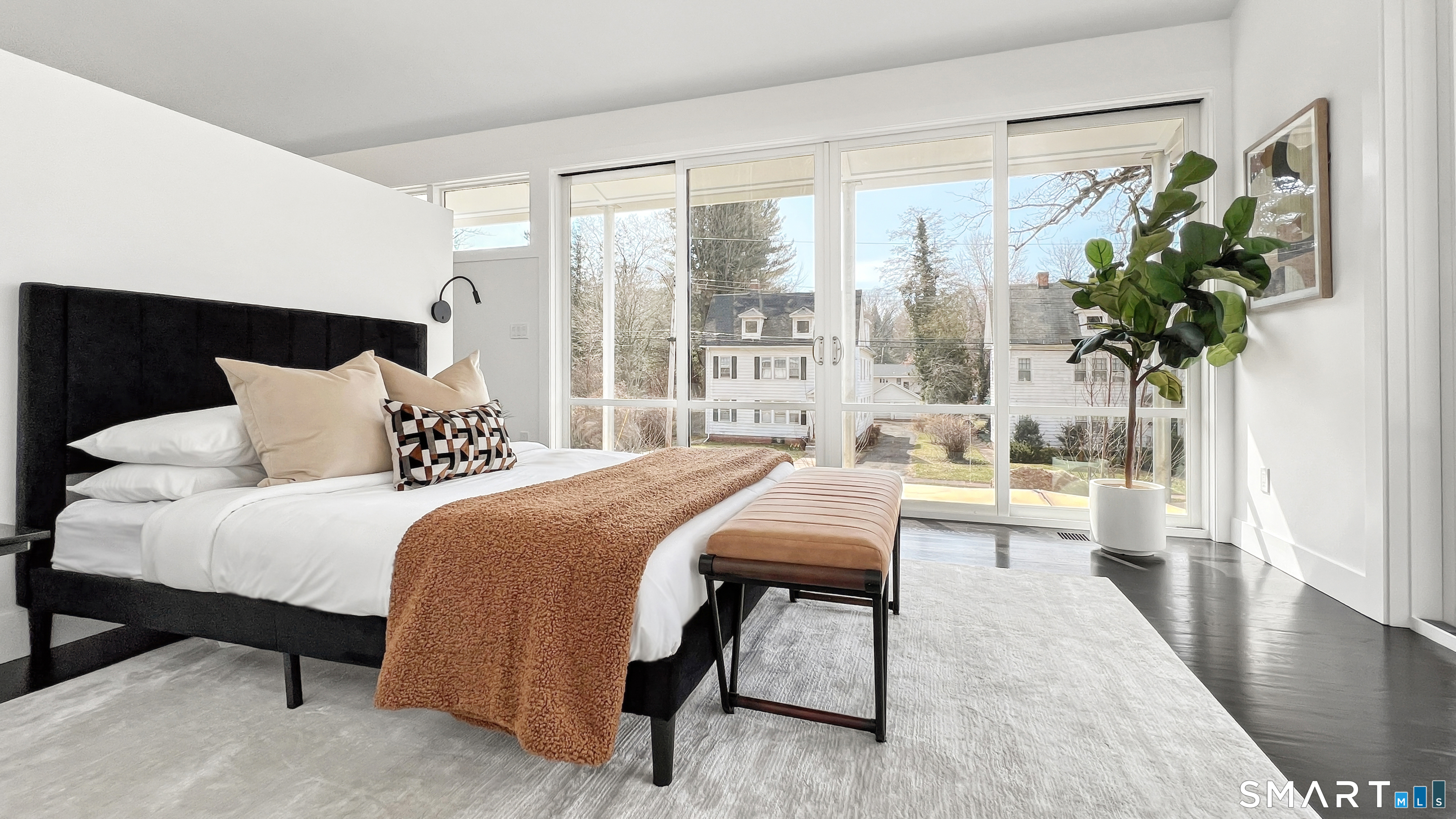 169 Mill Rock Road Hamden, CT 06517 - Photo 22 of 40 a bedroom with a bed and a potted plant