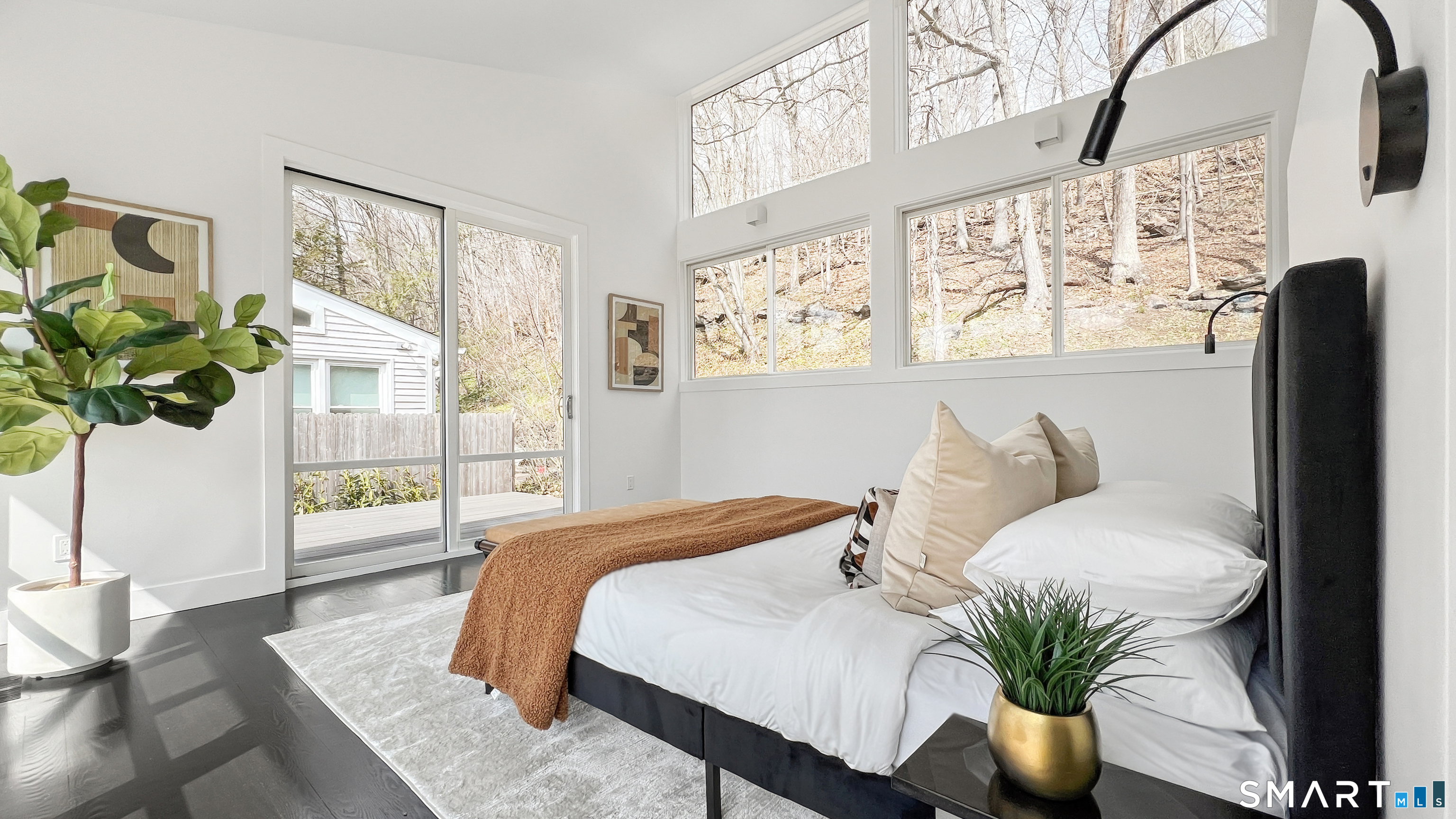 169 Mill Rock Road Hamden, CT 06517 - Photo 24 of 40 a bedroom with a large bed and a potted plant
