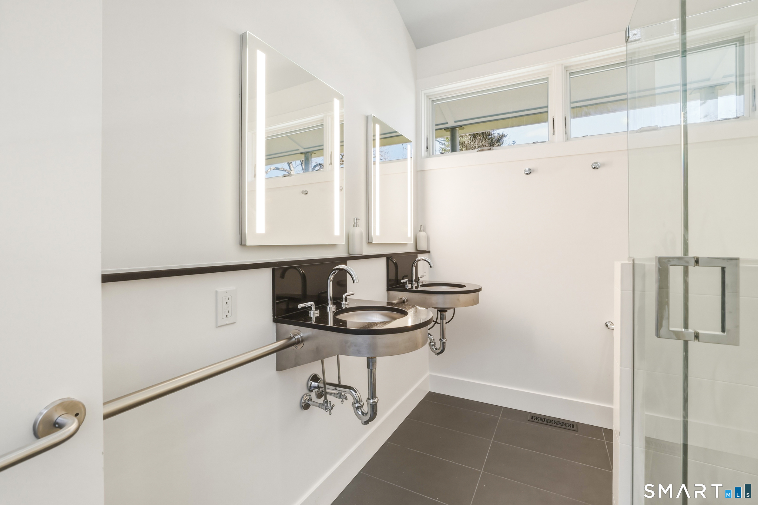 169 Mill Rock Road Hamden, CT 06517 - Photo 29 of 40 a bathroom with a sink a mirror and a shower