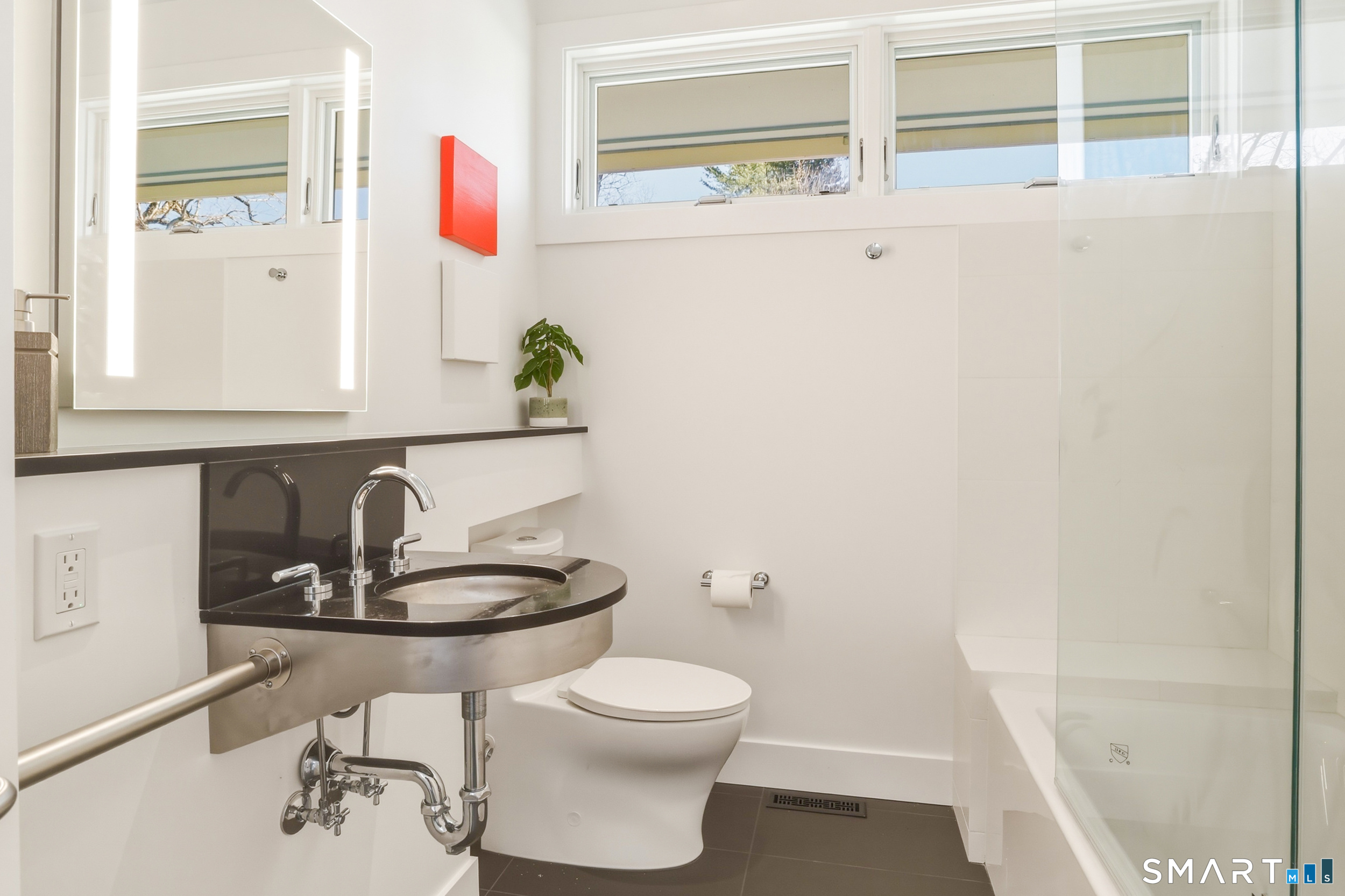 169 Mill Rock Road Hamden, CT 06517 - Photo 37 of 40 a bathroom with a sink a toilet and a mirror