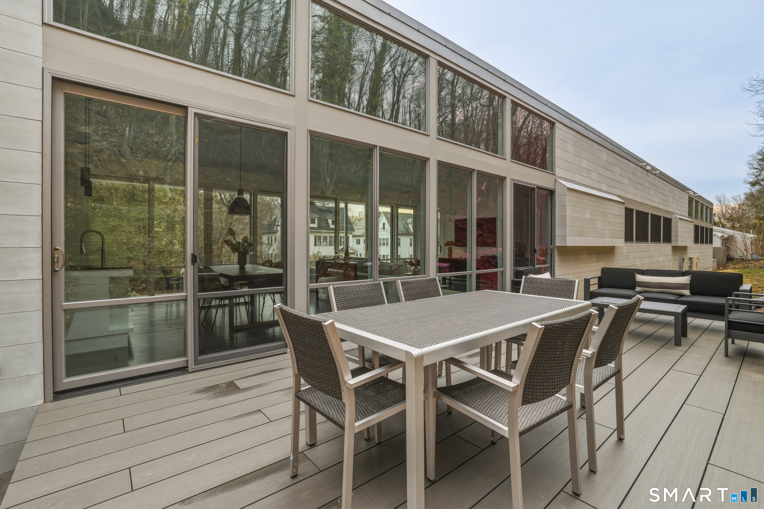 169 Mill Rock Road Hamden, CT 06517 - Photo 4 of 40 a dinning table and chairs in patio of the house