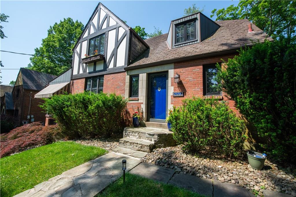 108 Cascade Road Pittsburgh, PA 15221 - Photo 1 of 42 a view of a brick house with a yard plants and large tree