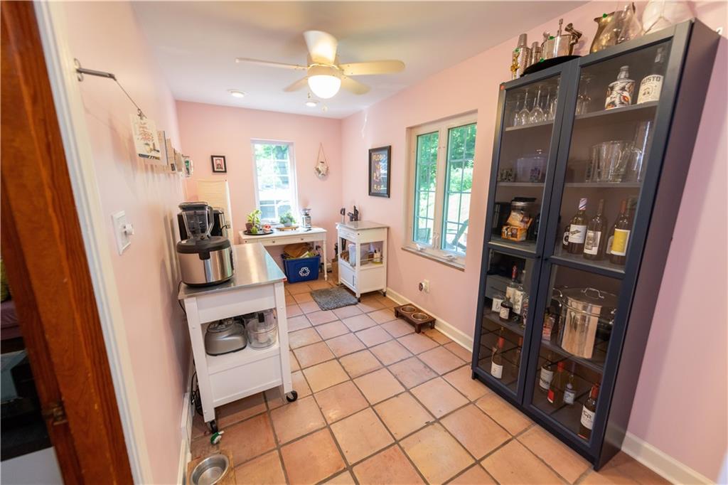 108 Cascade Road Pittsburgh, PA 15221 - Photo 14 of 42 a living room with furniture a flat screen tv and a floor to ceiling window
