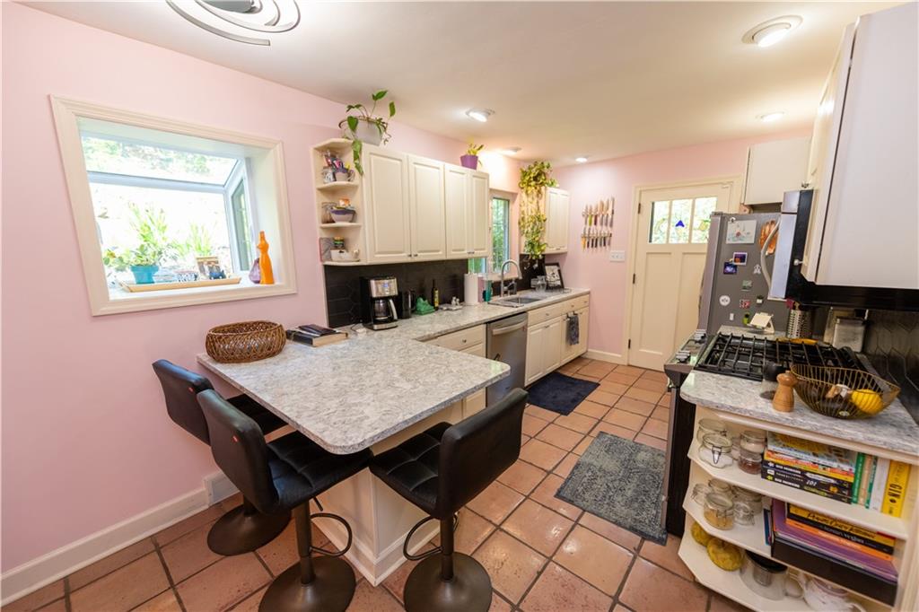 108 Cascade Road Pittsburgh, PA 15221 - Photo 15 of 42 a dining room with furniture and a flat screen tv