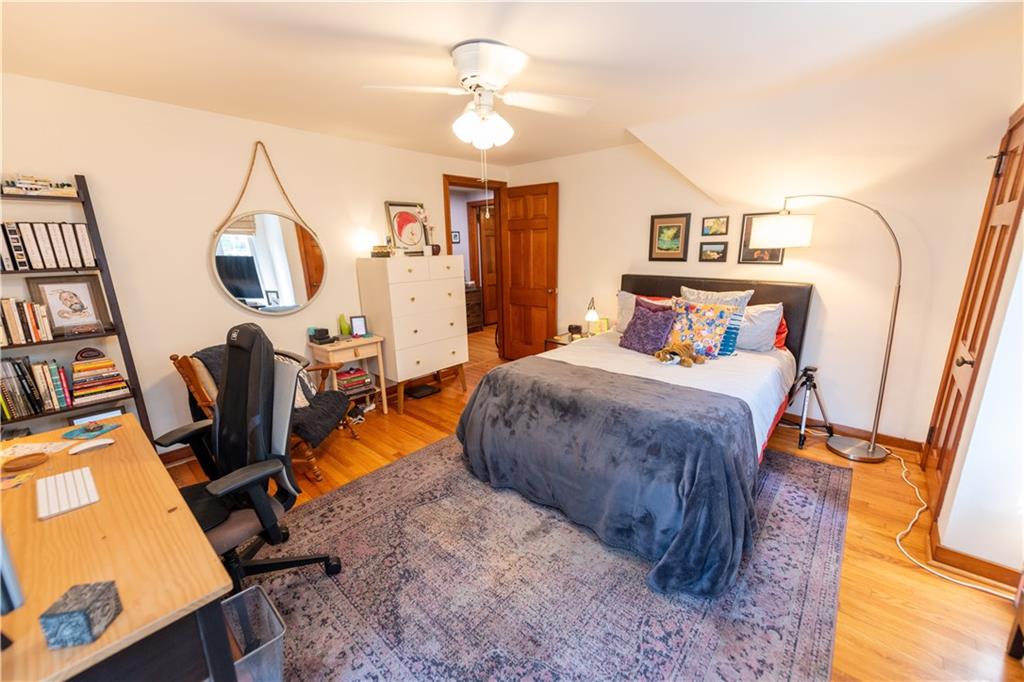 108 Cascade Road Pittsburgh, PA 15221 - Photo 25 of 42 a bedroom with a bed and a chandelier