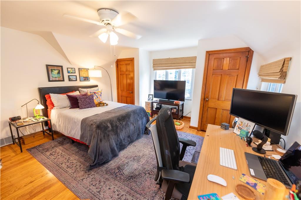 108 Cascade Road Pittsburgh, PA 15221 - Photo 26 of 42 a bedroom with a bed and a flat screen tv