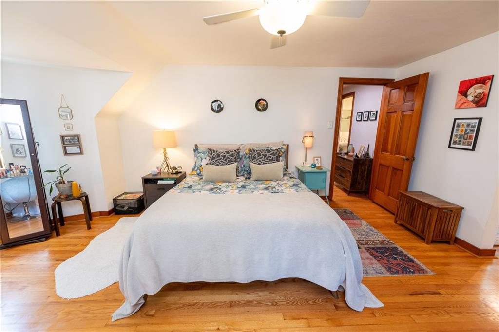 108 Cascade Road Pittsburgh, PA 15221 - Photo 31 of 42 a bedroom with a bed and wooden floor