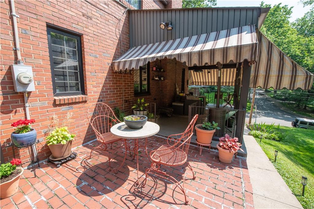 108 Cascade Road Pittsburgh, PA 15221 - Photo 40 of 42 a view of a patio with table and chairs potted plants with wooden fence