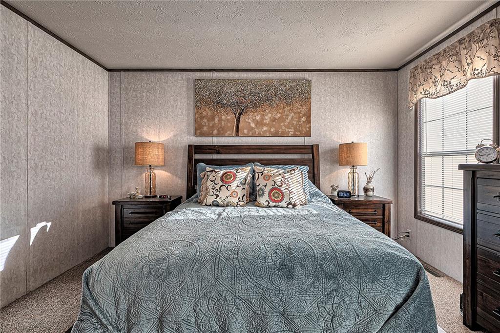 104 Clifton Street Derry, PA 15627 - Photo 12 of 35 a bed sitting in a bedroom next to a window