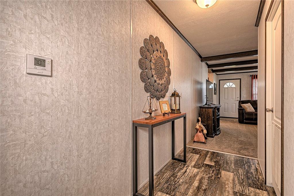 104 Clifton Street Derry, PA 15627 - Photo 17 of 35 a view of hallway with wooden floor and a potted plant