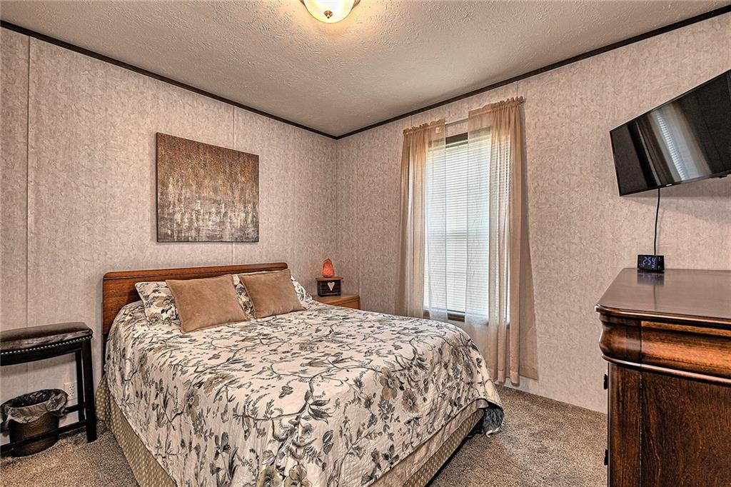 104 Clifton Street Derry, PA 15627 - Photo 22 of 35 a bedroom with a bed and a flat screen tv