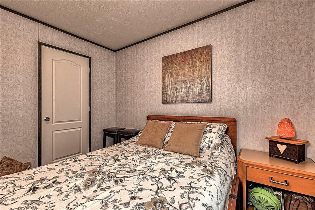 104 Clifton Street Derry, PA 15627 - Photo 23 of 35 a bedroom with a bed and wooden floor