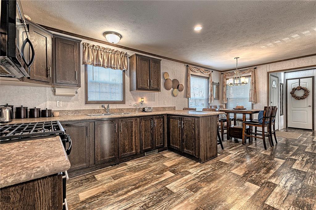 104 Clifton Street Derry, PA 15627 - Photo 8 of 35 a kitchen with stainless steel appliances granite countertop a stove a sink and a microwave