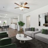 a living room with furniture potted plant and a window