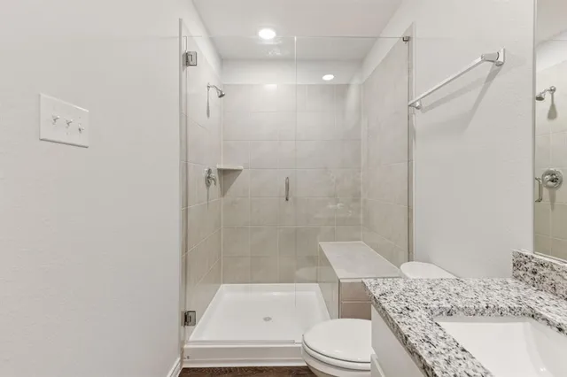 a bathroom with a sink toilet and shower