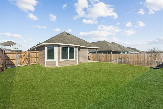 a view of a house with a yard and sitting area