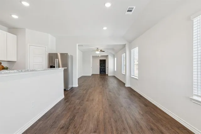 a view of a kitchen with a sink and a refrigerator