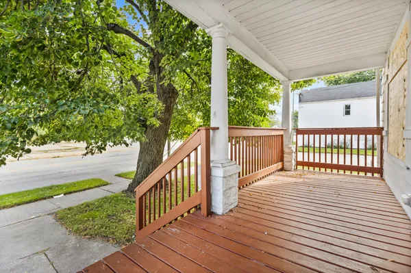 a view of a balcony with wooden floor
