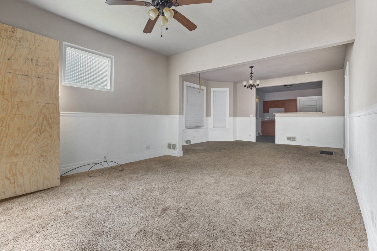 631 East 142nd Street Dolton, IL 60419 - Photo 19 of 29 an empty room with chandelier fan and windows