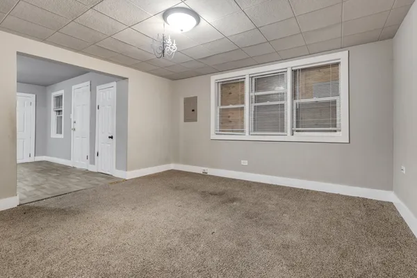 an empty room with a empty space and windows