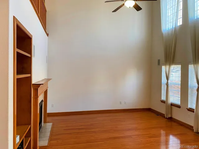 a view of an empty room with window and cabinet