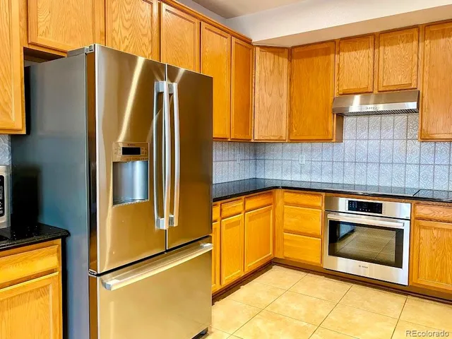 a kitchen with a sink and a refrigerator
