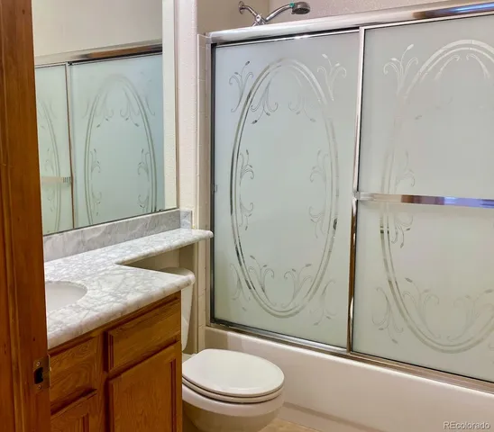 an empty room with wooden floor and entrance