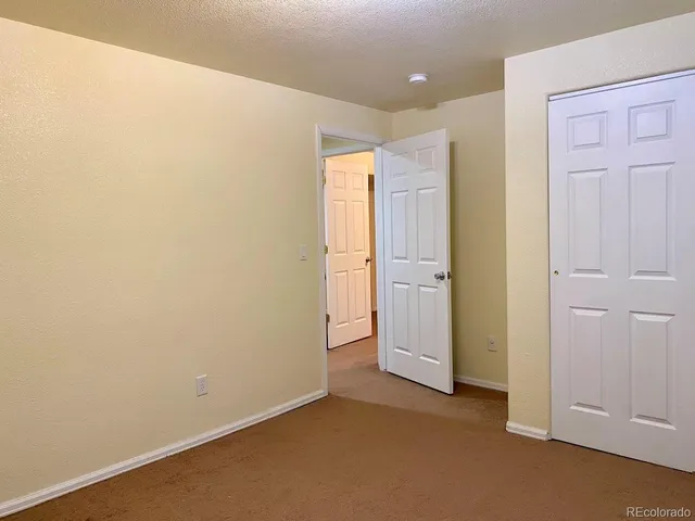 an empty room with closet area