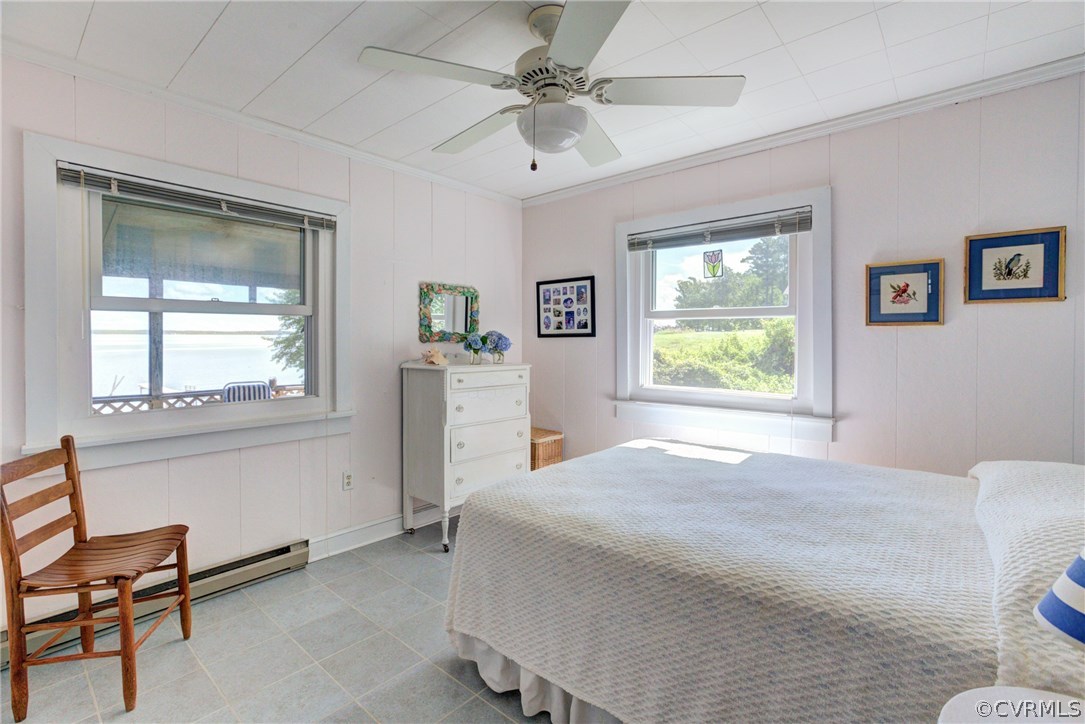 528 Old Mill Point Road Laneview, VA 22504 - Photo 17 of 30 a bedroom with a bed and a chandelier