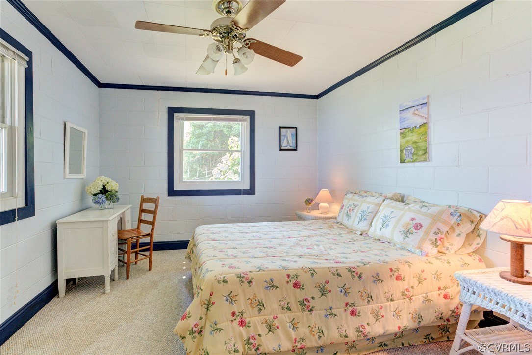 528 Old Mill Point Road Laneview, VA 22504 - Photo 18 of 30 a bedroom with a bed and a chandelier