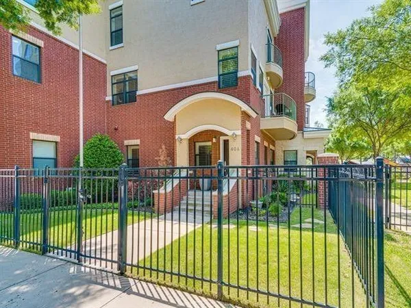 front view of a brick house with a yard