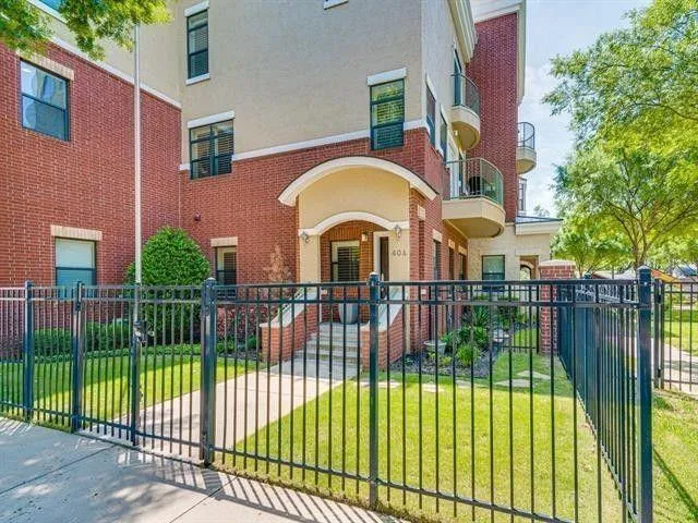 front view of a brick house with a yard
