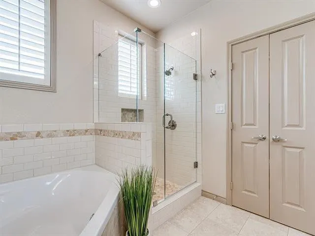 a bathroom with a bathtub and shower