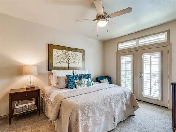 a bedroom with a bed and a large window