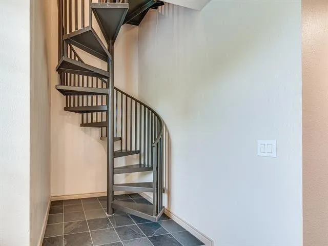 a view of balcony with lots of green space