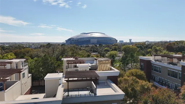 a kitchen with stainless steel appliances granite countertop a sink a stove and a wooden floors