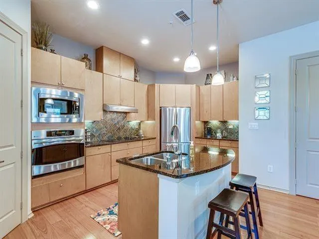 a kitchen with sink dining table and chairs