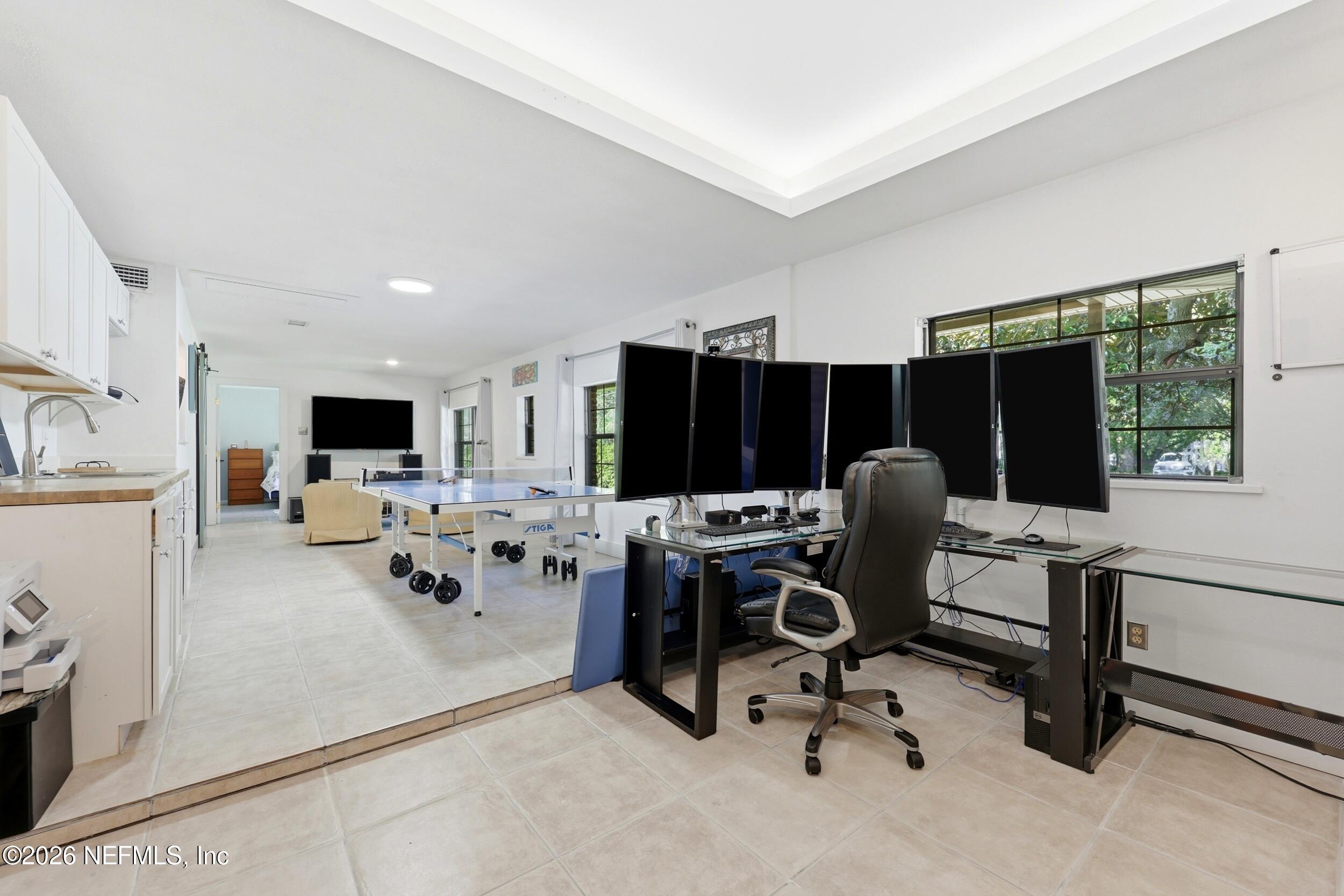 11627 Mandarin Terrace Road Jacksonville, FL 32223 - Photo 43 of 79 a view of a workspace with furniture and a flat screen tv