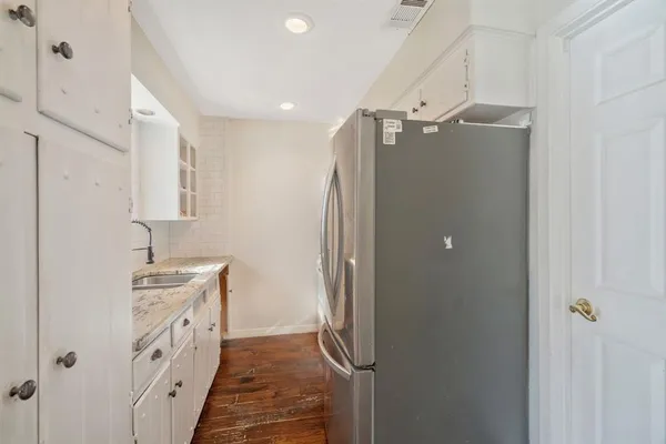 a kitchen with stainless steel appliances granite countertop a refrigerator and a sink