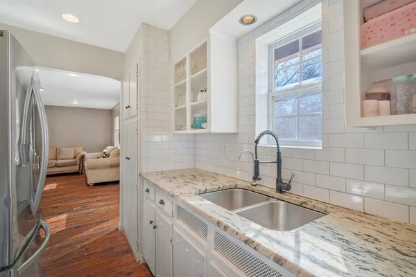 a en suite bathroom with a granite countertop sink