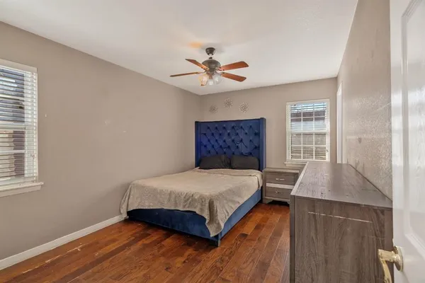 a bedroom with a bed and a window with a chandelier