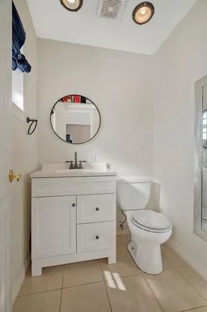 a bathroom with a toilet sink and mirror